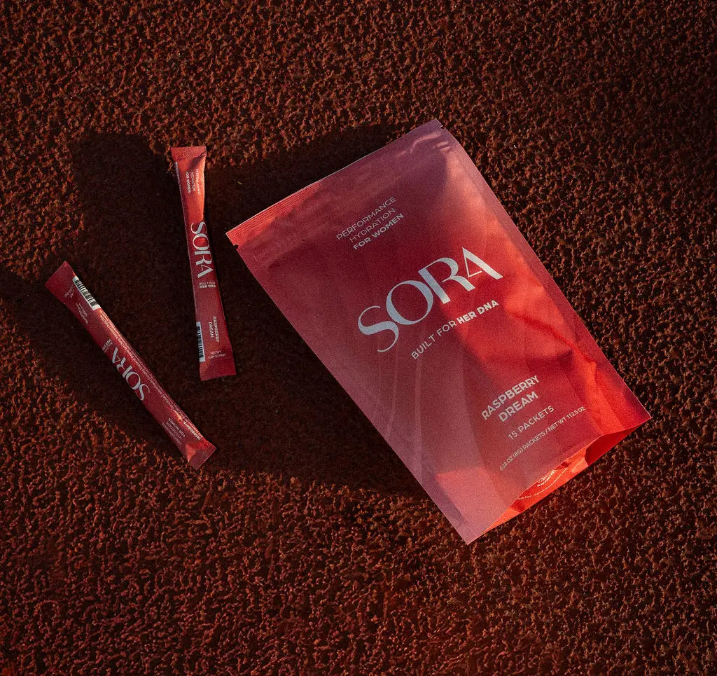 SORA Raspberry Dream pouch and stick packs on a running track