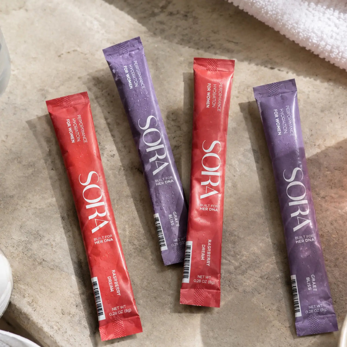 Four SORA stick packs, two Raspberry Dream and two Grape Bliss