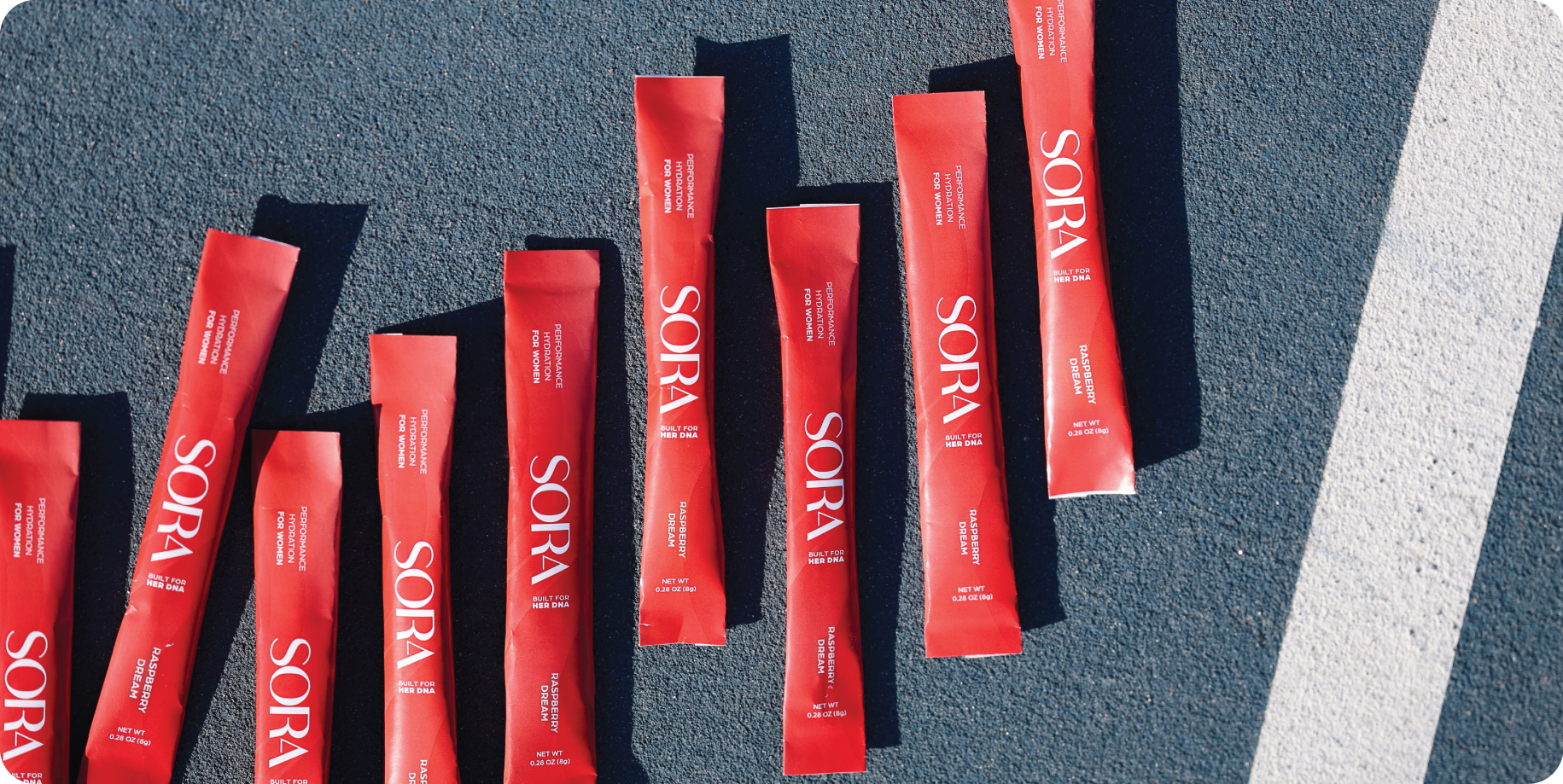 Red SORA packets arranged on a textured surface